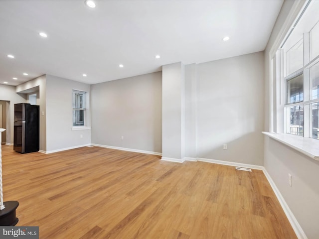 unfurnished living room with light hardwood / wood-style floors