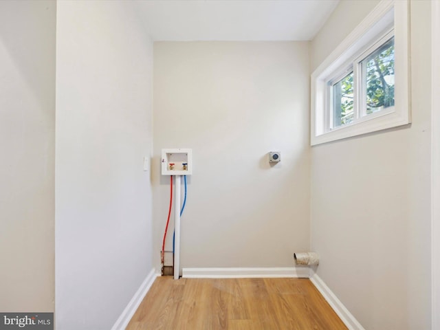 laundry area featuring hookup for a washing machine, hookup for an electric dryer, and light hardwood / wood-style flooring