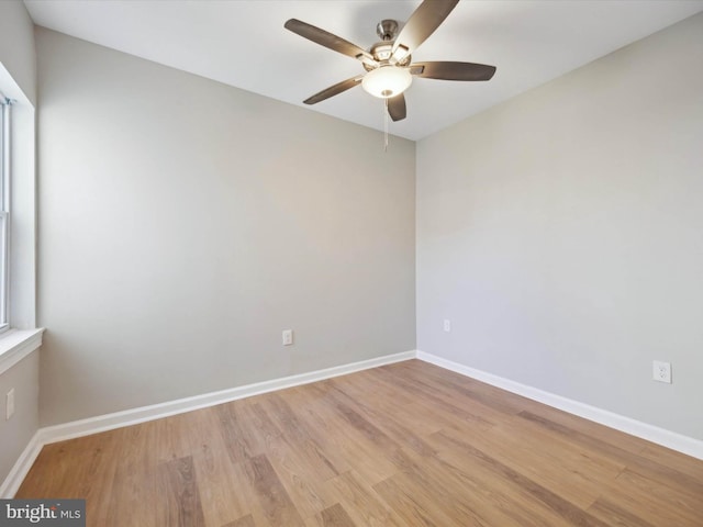 spare room with light wood-type flooring and ceiling fan