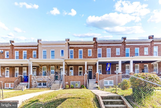 view of property with a front yard and a porch