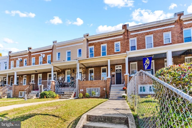 multi unit property featuring a front yard and a porch