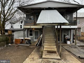 back of house featuring a balcony