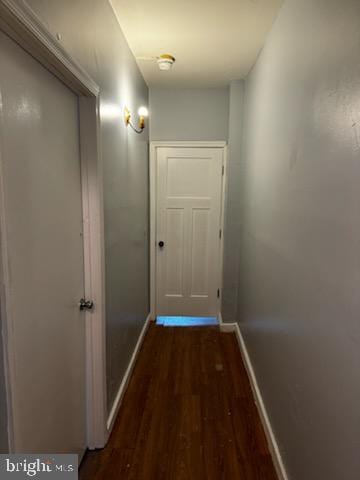 corridor with dark hardwood / wood-style floors