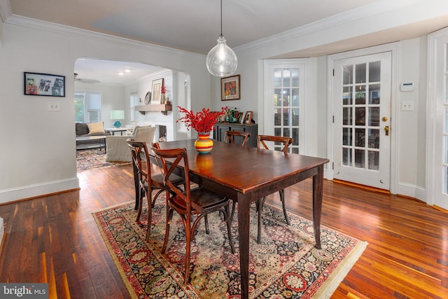 dining area with crown molding and hardwood / wood-style floors