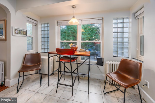 tiled dining area with radiator heating unit