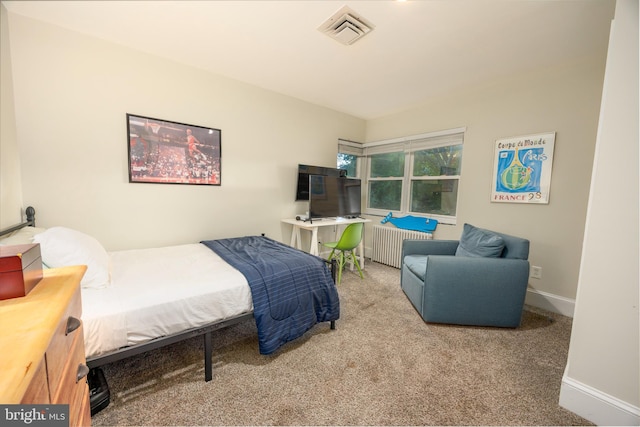 carpeted bedroom with radiator heating unit