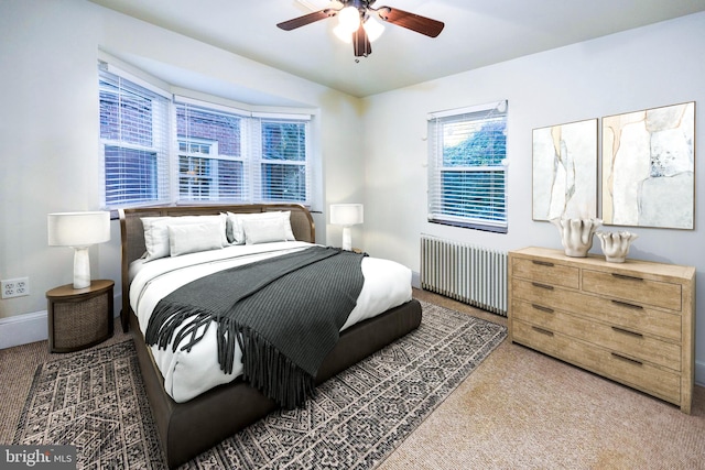 bedroom featuring radiator, ceiling fan, and carpet floors