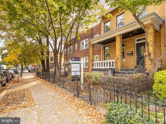 townhome / multi-family property featuring covered porch