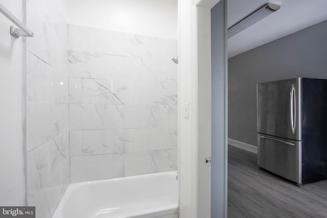 bathroom featuring tiled shower / bath and wood-type flooring