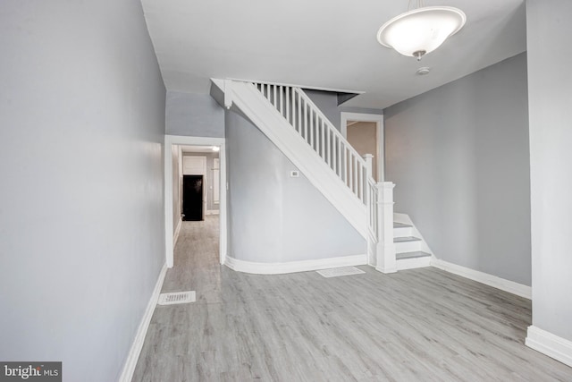 stairs with wood-type flooring