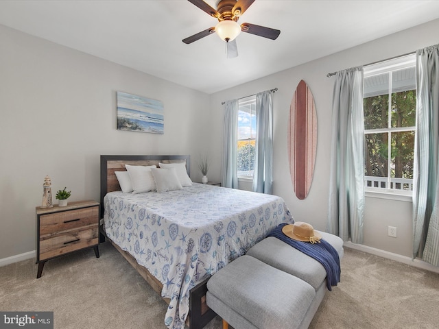 bedroom featuring ceiling fan and light carpet