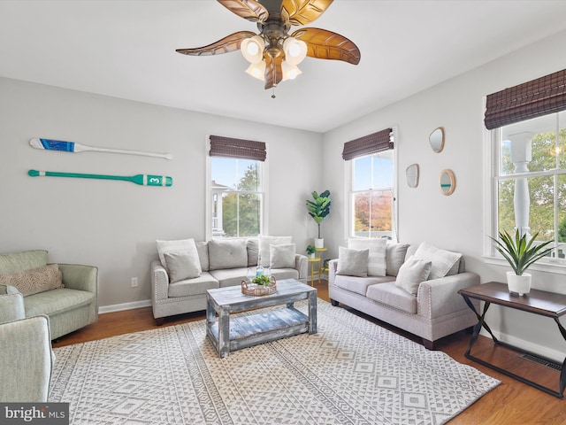 living room with hardwood / wood-style floors and ceiling fan