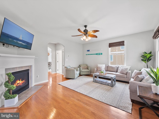 living room with hardwood / wood-style floors, a fireplace, and ceiling fan