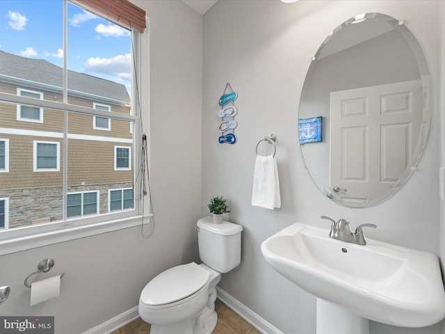 bathroom featuring sink, toilet, and tile patterned flooring