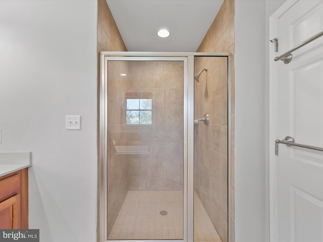 bathroom featuring vanity and a shower with door