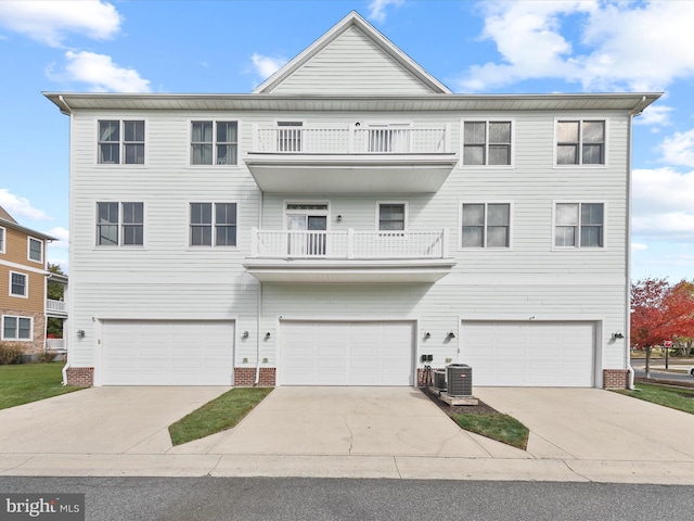 multi unit property featuring central AC, a balcony, and a garage