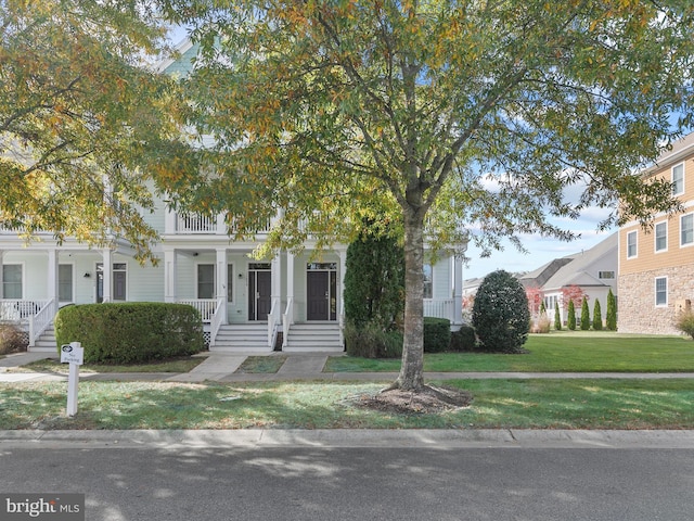 view of front of house featuring a front yard and covered porch