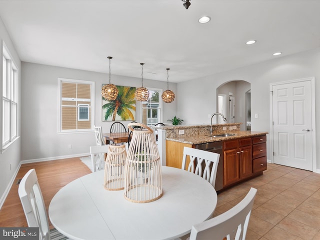 dining room featuring sink and light tile patterned floors