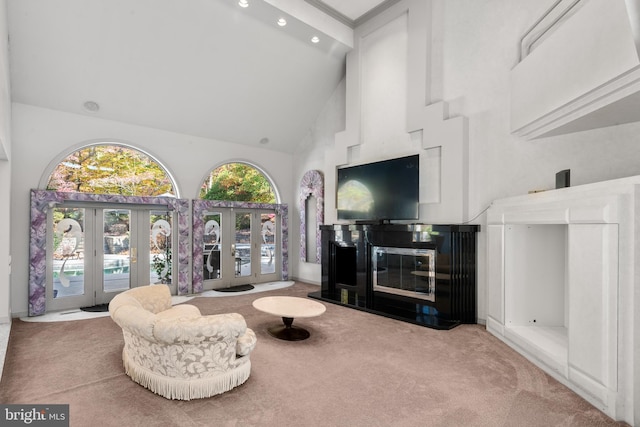 living room featuring french doors, high vaulted ceiling, and light colored carpet