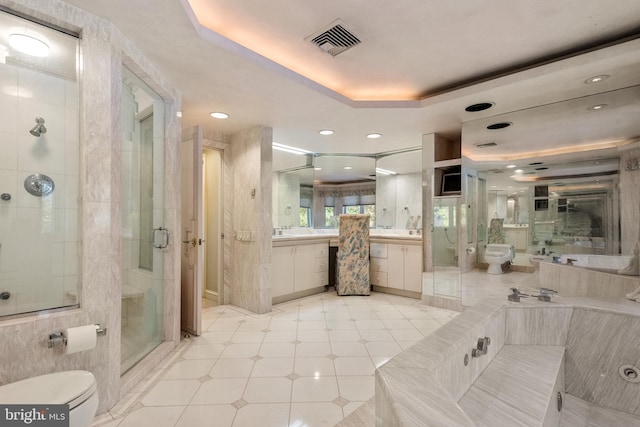 full bathroom featuring vanity, a tray ceiling, toilet, and a bidet