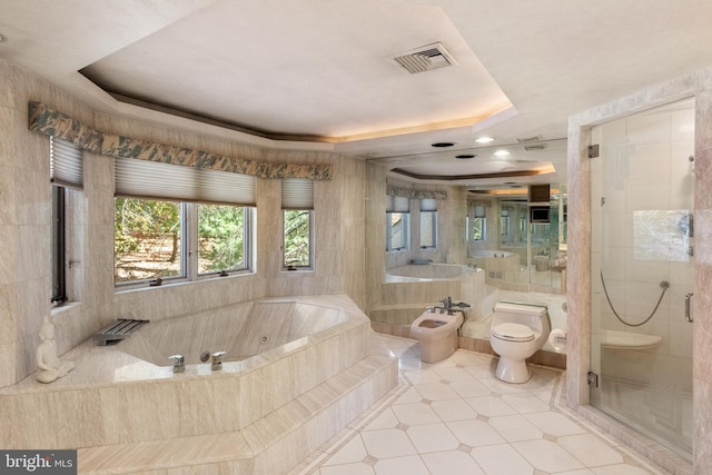 bathroom featuring tile patterned floors, a raised ceiling, a bidet, shower with separate bathtub, and toilet