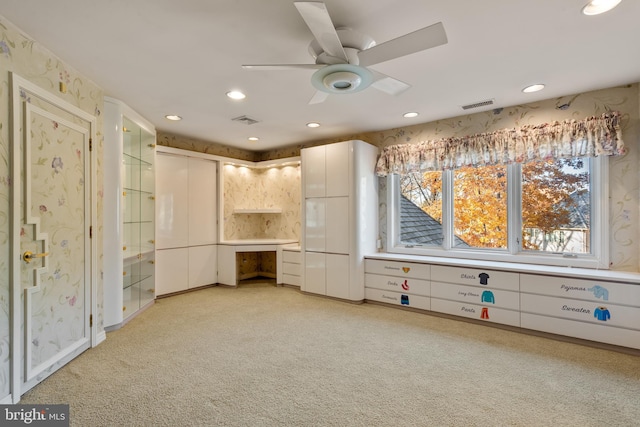 interior space with ceiling fan and light colored carpet