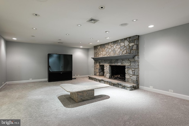 unfurnished living room featuring carpet floors and a stone fireplace