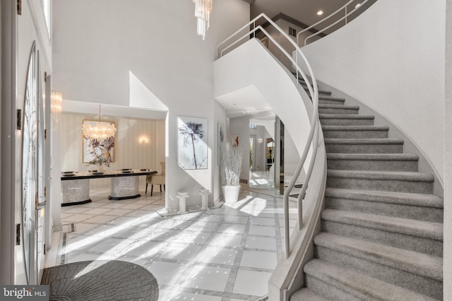 entrance foyer featuring a high ceiling and light tile patterned floors