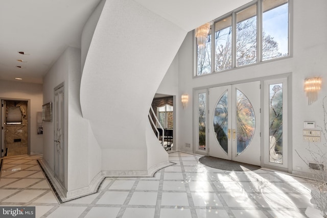 foyer featuring french doors and a chandelier