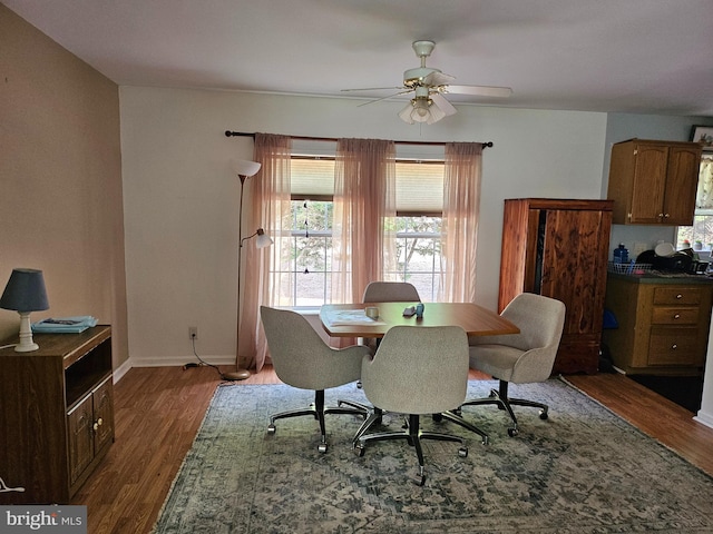 dining area featuring ceiling fan and dark hardwood / wood-style flooring