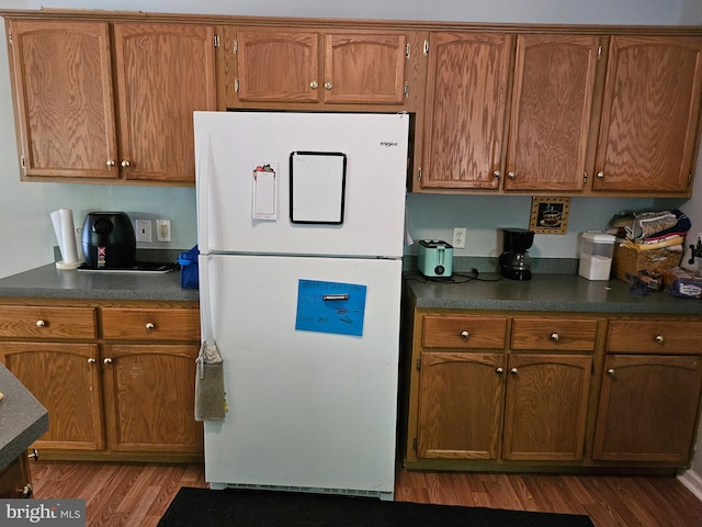 kitchen featuring white fridge and dark hardwood / wood-style flooring