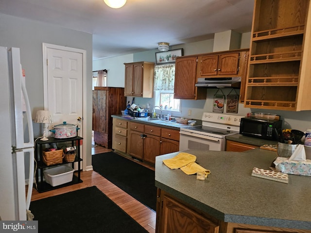 kitchen with white appliances, light hardwood / wood-style floors, and sink