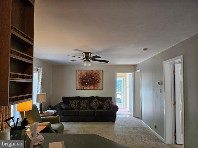 carpeted living room featuring ceiling fan