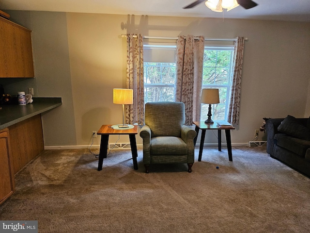 sitting room with carpet flooring and ceiling fan