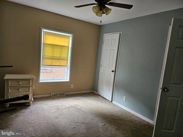 unfurnished bedroom with ceiling fan and carpet