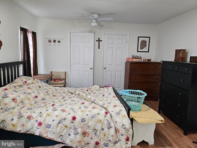 bedroom with ceiling fan and dark hardwood / wood-style floors