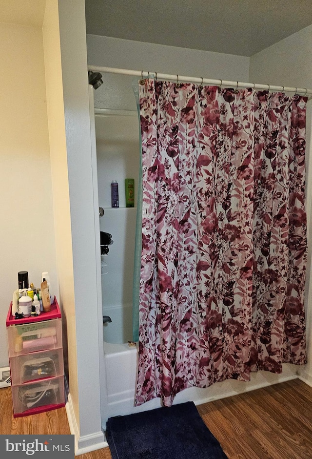 bathroom featuring shower / bath combo and hardwood / wood-style flooring