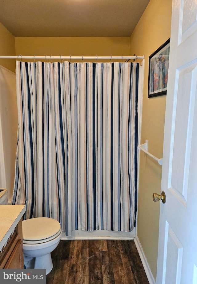 bathroom with vanity, toilet, wood-type flooring, and a shower with curtain