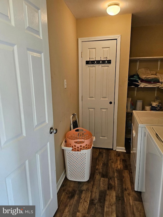 washroom featuring dark wood-type flooring and independent washer and dryer