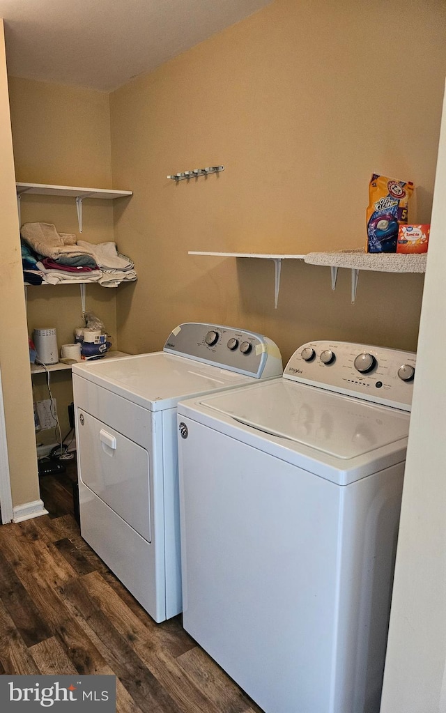 clothes washing area featuring washer and dryer and dark hardwood / wood-style floors