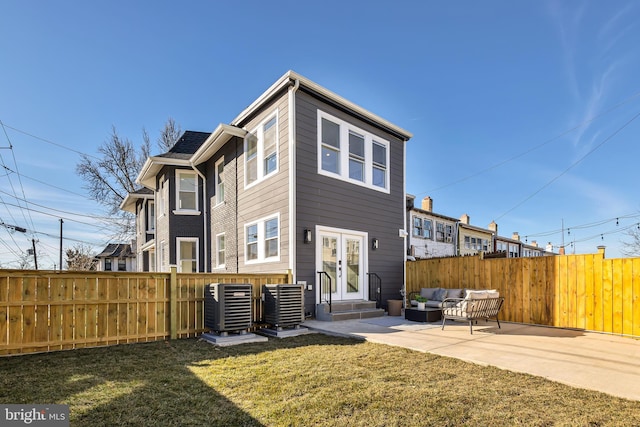 back of house featuring a patio, central AC, a yard, and an outdoor hangout area