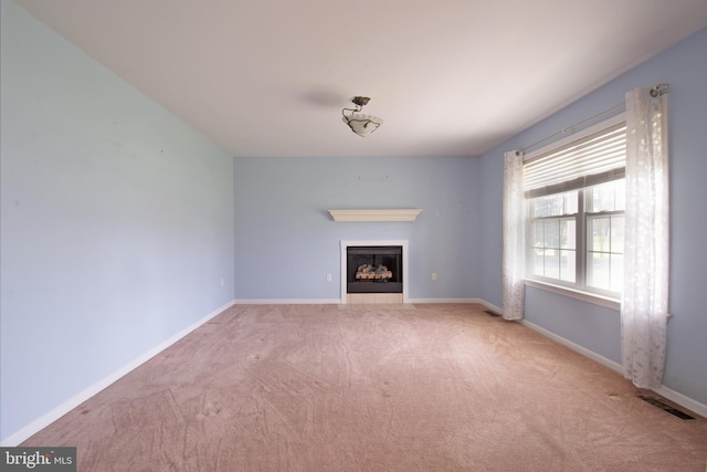 unfurnished living room with light colored carpet