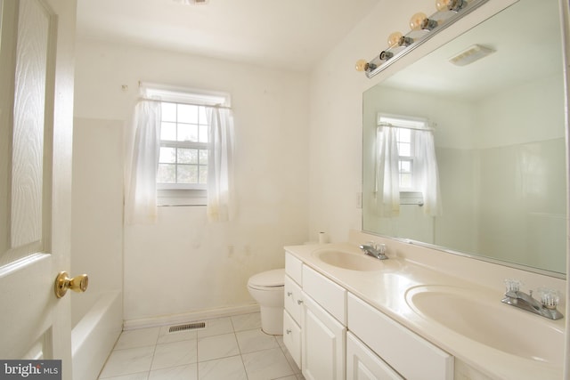 full bathroom with toilet, vanity, tile patterned floors, and a wealth of natural light