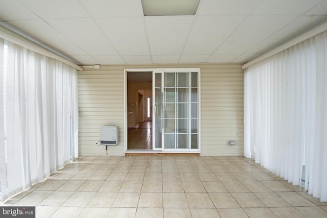 unfurnished sunroom featuring a paneled ceiling