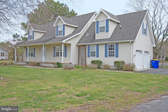 new england style home with a front yard, a garage, and a porch