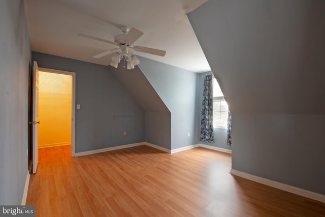 additional living space with light hardwood / wood-style floors, ceiling fan, and vaulted ceiling