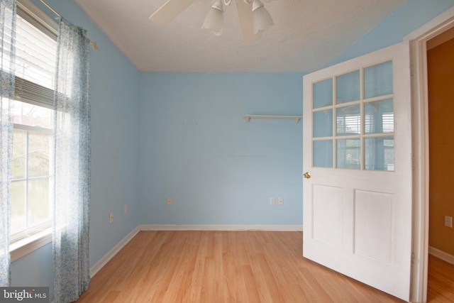 unfurnished room with light hardwood / wood-style floors and ceiling fan