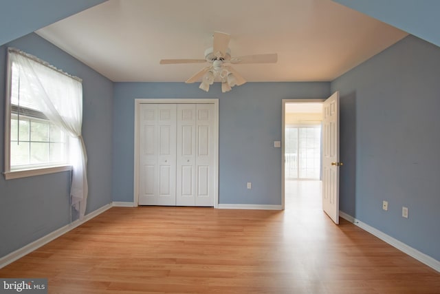 unfurnished bedroom with a closet, ceiling fan, and light hardwood / wood-style flooring