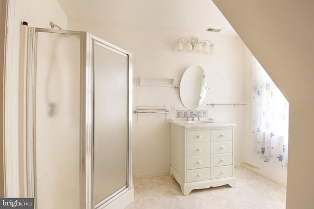 bathroom featuring vanity and an enclosed shower