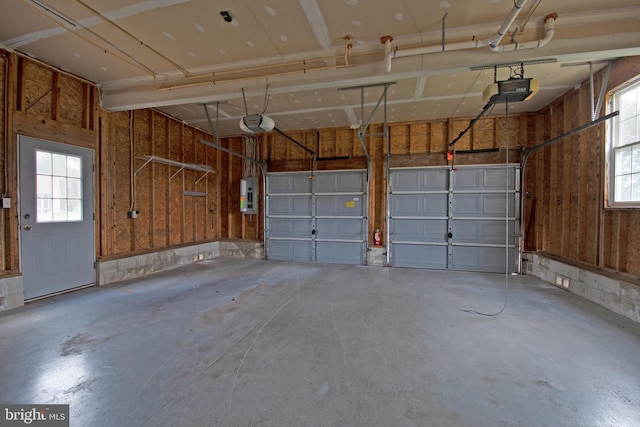 garage featuring electric panel and a garage door opener